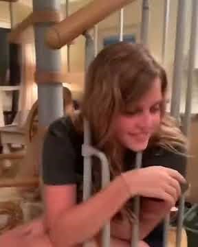 Girl gets her head stuck in staircase railing.