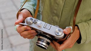 young girl with a camera. Fashionable and attractive beautiful woman with an analog film camera in her hands. travel and vacation.