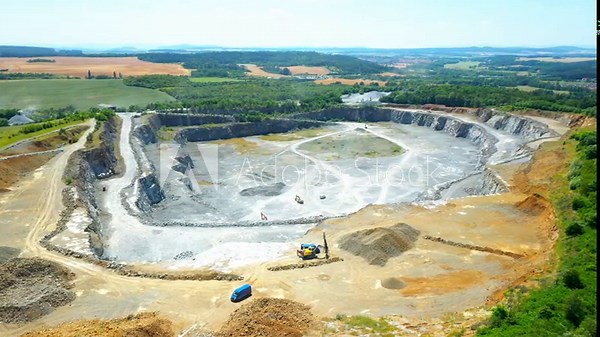 Stone quarry. Open cast mining. Industrial landscape. Heavy industry from above. Aerial view to big source of emissions.
