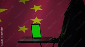Chinese engineer uses green screen tablet to make fake accounts on social media promoting communist ideology. Technician doing cybersecurity job for CCP government with mockup device, camera B