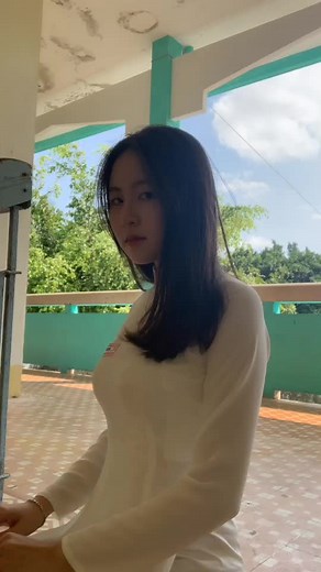 Young Woman Posing Outdoors in Serene Setting