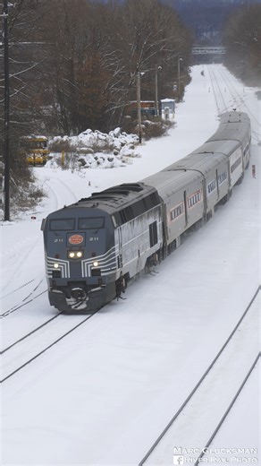 River Rail Photo on Instagram: "Central In The Snow. On Saturday, December 27, 2025, MTA Metro-North Railroad Train 8827 was led by MNCW 211 (P32AC-DM, New York Central Heritage). The train is seen approaching Long Dock Road in Beacon, New York, with the Hudson Highlands in the background, a classic New York Central scene. MNCW 211 commemorates the time period from the building of this line to 1968, when New York Central operated trains on the Hudson and Harlem Lines. It is one of eight Metro-No