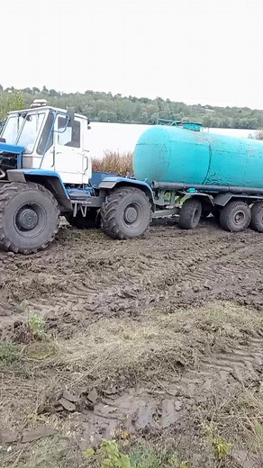 Farming Equipment in Action: Blue Tractor and Pump