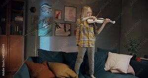 Home lesson boy kid playing the violin. Creative music activities for children during coronavirus covid 19 quarantine. Elementary school talented pupil learning and practice string music at home