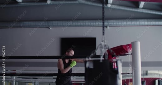 The female boxer trains hard on shadow fighting, combining agility and speed to perfect her boxing technique and overall conditioning.