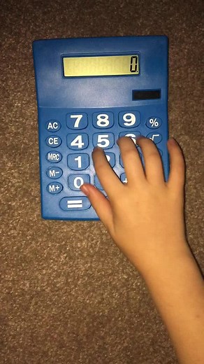 Child Engaging with Blue Calculator: A Learning Moment