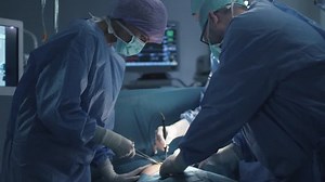 Medical Team Performing Surgical Operation in Modern Operating Room. Shot on RED Cinema Camera.