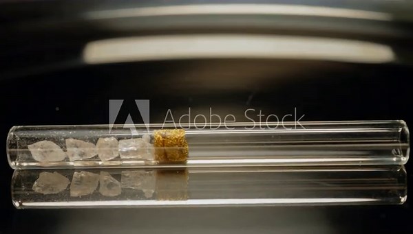 Crystal meth drug in rocks with smoking crack pipe on the table of addict. Addiction and drugs trafficking. Illicit drugs very potent and addictive, substances altered for street sale by drug dealer.