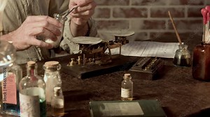 A 19th century Apothecary using a balance scale to determine the amount of substance he will use to formulate his medicinal remedy.