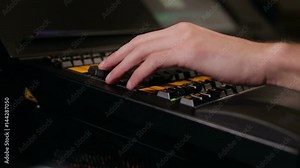 Man works using mixing console in sound recording studio.