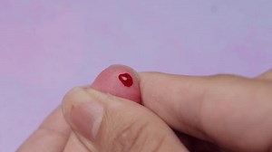 Poking their finger to obtain a blood sample