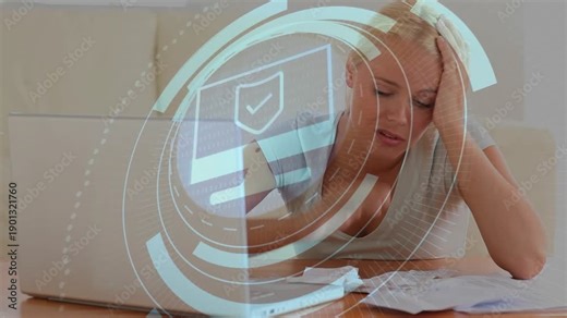 Woman holding head, pressing laptop keys and activating shield overlay while sorting finance bills