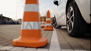 One of the traffic cones is knocked down during the practical driving test. Parking lesson in driving school
