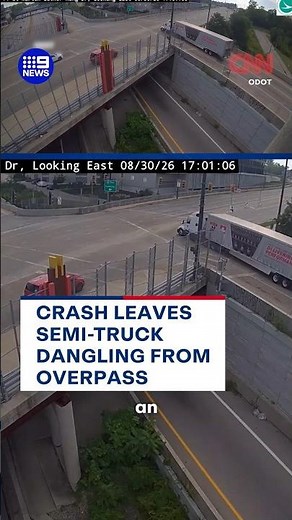Crash leaves semi-truck dangling from overpass | 9 News Australia