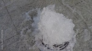 Fountain in slow motion. Stream Water splashes of a embedded source, geyser. Streetscape, Square in the city center. Wet slowmotion.