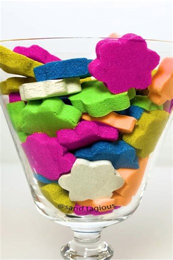 Colorful sand art pieces in a glass jar