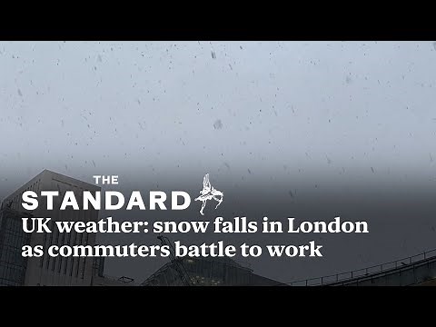 UK weather: snow falls in London as commuters battle to work