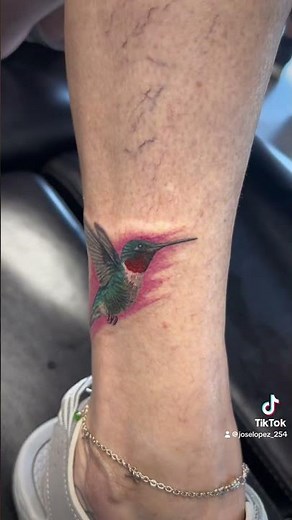 Hummingbird Tattoo | Colorful Mid-Flight Design on the Leg by Mi Vida Tattoos