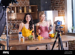 Cheerful female bloggers recording a video Stock Photo - Alamy