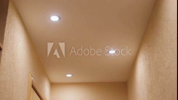 Small lights in the ceiling that illuminates the corridor. Turn the ceiling light on and off in the room.