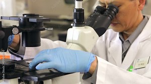 Male Scientist Using Microscope In Laboratory Stock Video