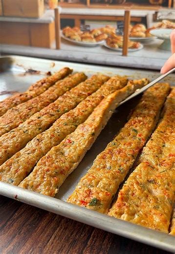 Easiest Sheet Pan Chicken Kebabs 🤤 Ingredients 2lbs ground chicken (or any ground meat) 1.5 bell peppers 4 large shallots 5 peeled garlic cloves 1/4 cup chopped parsley 2 teaspoons kosher salt 1/2 teaspoons pepper 1 teaspoon paprika 1 teaspoon dry oregano oil, for the sheet pan Directions: Preheat oven to 375F. In a food processor, add the shallots (or onion), garlic cloves, and diced bell pepper. Process until fine. Pour this mixture into a cheesecloth over a bowl and squeeze out as much water