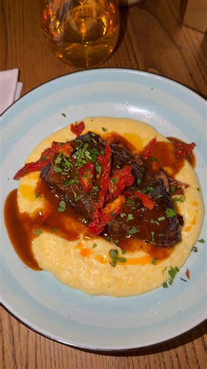 Come on in and warm up with our Barolo-braised short rib. Slow cooked in tomato, onion, garlic and red wine and finished over creamy polenta for the coziest winter bite! 🍷 | Luogo Restaurant
