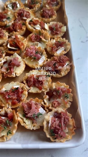 Tawnie Graham on Instagram: "@krolls_korner MINI BRIE BITES 🥰 the perfect holiday app! Comment “recipe please” and I’ll dm the recipe link over to you! . https://krollskorner.com/recipes/appetizers-snacks/mini-brie-bites/ . Ingredients ▢ 3 oz. prosciutto ▢ 2, 1.9 oz. packages of Athens Phyllo Shells ▢ 8 oz. triple creme brie cheese wheel, place in freezer for 15-20 minutes to firm up ▢ 8.5 oz. jar fig jam ▢ 1 tbsp. fresh thyme . #minibriebites #briebites #brieappetizer #holidayappetizers