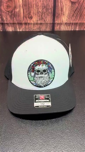 bearded santa skull hat Bring bold holiday spirit and fearless style to your wardrobe with the Bearded Santa Skull Holiday Beardmas Edition Richardson Hat. This skull Santa beard trucker hat fuses Christmas cheer with rugged, edgy beard culture, featuring an embroidered skull with a legendary full beard, Santa hat, and festive string lights. Snowy pines and winter skies complete the design, making it a standout piece for men who love unique, holiday-inspired apparel with attitude bearded santa s