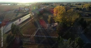 Traffic on the Highway 14 near Fort Collins Colorado fall 2021. Small farm properties and lens flares.
