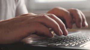 Hands on keyboard. Freelancer busy worker working with modern laptop device. Businessman, entrepreneur working on laptop at home. Close-up. Male professional with help of a computer, works well.