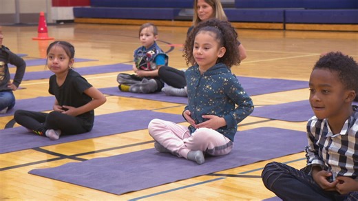 CPS teaching some elementary students yoga to improve focus in the classroom