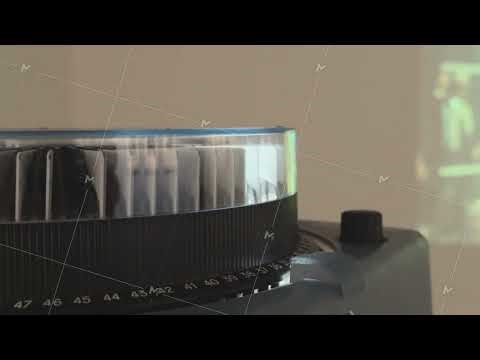 Vintage carousel slide projector running in a dark room with sound,