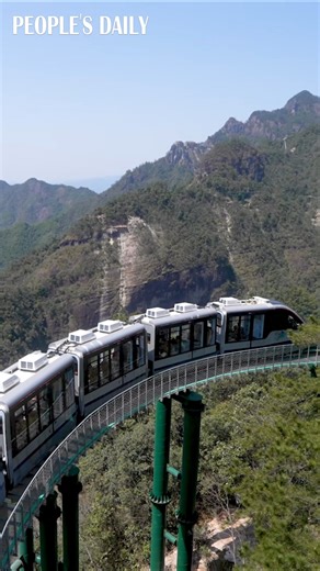 Welcome aboard the one-of-a-kind "cliff shuttle train" in east China's Dajue Mountain! The train leaves visitors "hanging" in the air at an elevation between 850 and 1,150 meters above sea level, running deep within the lush forest for a heart-pounding adventure! | VideoChina