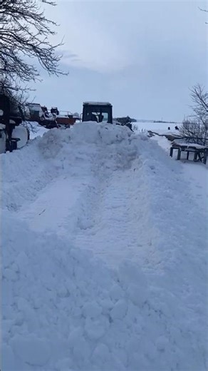 A bulldozer is clearing a massive snowdrift. #snow #bulldozer