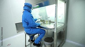 Checking release rate of drug from capsule based on capsule breakdown in lab. A scientist checks drug release rate of capsules.