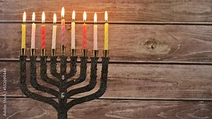 Menorah candles are lit by Jew preparation for Hanukkah with Jewish symbols