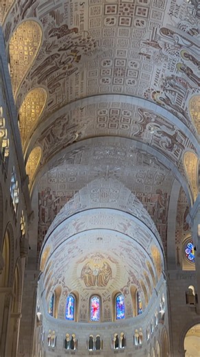 Inside the Basilica of Sainte-Anne-de-Beaupré, in Quebec Canada; we find the ceiling is covered with mosaics, that tell the story of Saint Anne’s life, her virtues, and her glorification. At the center above the main altar, Saint Anne offers a fruit to the child Jesus, a powerful symbol of His mission to bring life and redemption, as the fruit of salvation. Walking into the sanctuary, we find animals and plants, beautifully carved into the wooden pews, telling the story of Creation Reaching the 