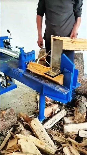 Blue hydraulic log splitter pressing wood, crisp rhythm of morning splitting craft