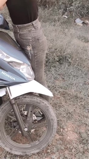 Young Woman with Honda Motorcycle in Outdoor Setting