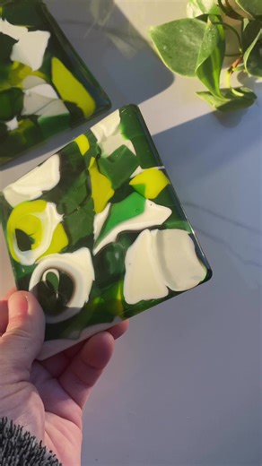 Finishing up some fun fused glass🍀 coasters 🍀 today before they head off to their forever home! These are made with tiny glass cut offs and then melted together in a mold at around 1500F. They are THICK & sturdy so they have to anneal for many, many hours before I can safely pop them out of their molds. I love how they turned out, what do you think? #glassfusing #glassart #meltingglass | Funky Glassworks