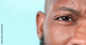 Confused, face and a black man on a studio background for doubt, question or thinking. Zoom, idea and closeup portrait of an African person with a frustrated expression and mockup space of an eye