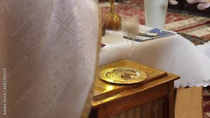 During a church wedding, the priest sprinkles the wedding rings with holy water. Church wedding traditions.