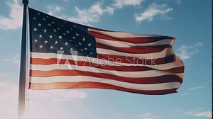 A large American flag is flying in the sky
