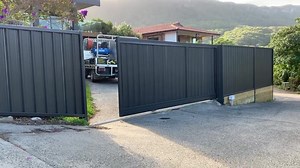 Motorised sliding gate Materials: Colorbond boundary fencing with timber sleeper retaining wall and motorised sliding gate. Colour: Monument Supplier: Dunn & Farrugia Fencing and Gates Location: Austinmer Such a beautiful location🏖 . We installed boundary fencing and a motorised sliding gate to give this property owner privacy and security as their property entrance is from a shared driveway. Contact us on 0423073713 for a quote for your fencing needs. #fencetastic #fencetasticnsw #fencerlife #