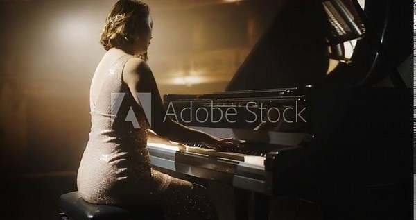 Classical Piano Concert: Under the Spotlight, Asian Female Pianist Delivering a Powerful Performance on the Grand Piano. Elegant Stage Setting Complements Her Passionate Playing. Zoom on Hands