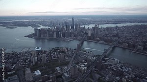 New York City wide angle aerial view of Brooklyn and Lower Manhattan while flying over the Brooklyn Bridge and Manhattan Bridge.