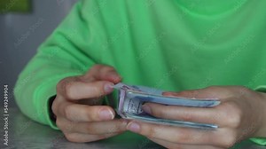 Young woman counting Turkish lira banknotes.