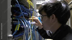 Engineer come to server room for work,check problem of network,repair server in the server room,thailand people,asian man