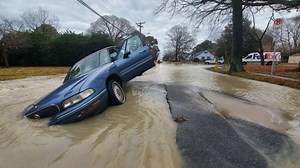 Car gets trapped in sinkhole that opens up in Bay View area of Norfolk